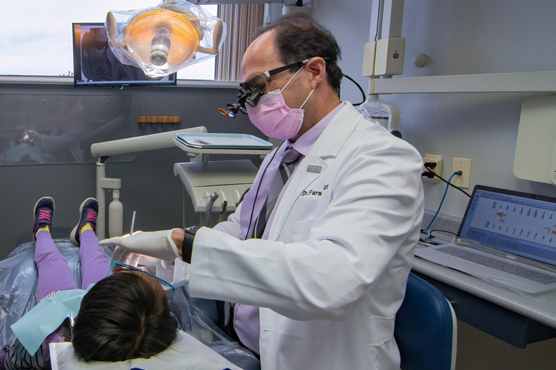 Dr Feizi with a child patient